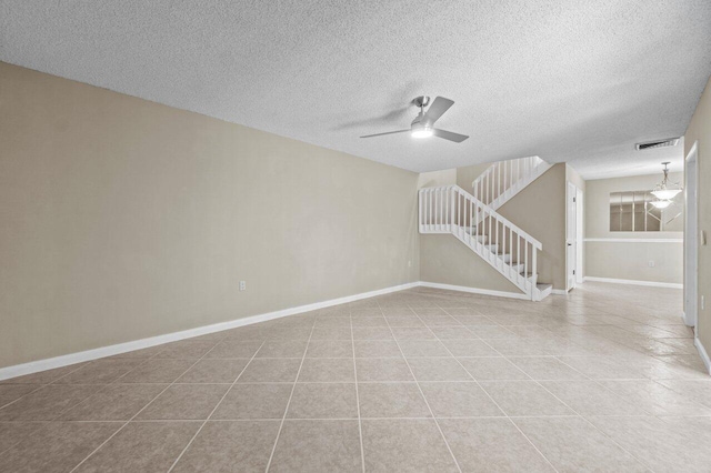 unfurnished room with light tile patterned flooring, a textured ceiling, and ceiling fan