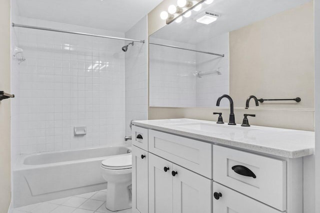 full bathroom with tiled shower / bath, vanity, toilet, and tile patterned flooring