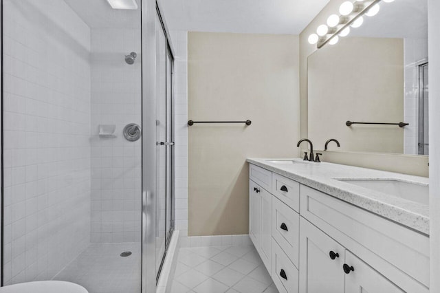 bathroom featuring walk in shower, tile patterned floors, and vanity