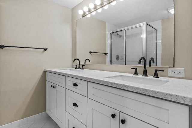 bathroom with vanity, tile patterned flooring, and a shower with door