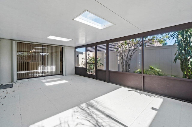 unfurnished sunroom featuring a skylight