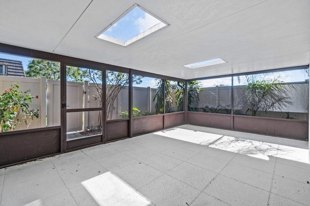 unfurnished sunroom with a healthy amount of sunlight and a skylight