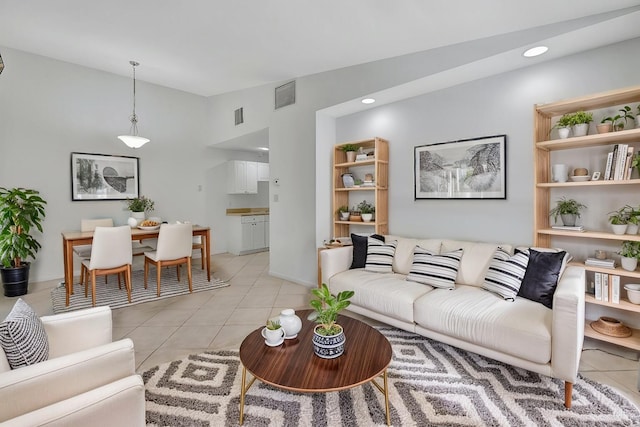 living room with recessed lighting, visible vents, vaulted ceiling, and light tile patterned floors