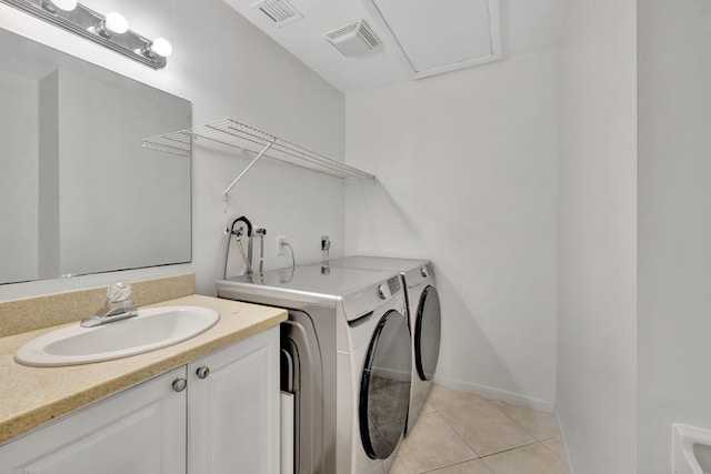 laundry area with a sink, laundry area, visible vents, and washer and dryer