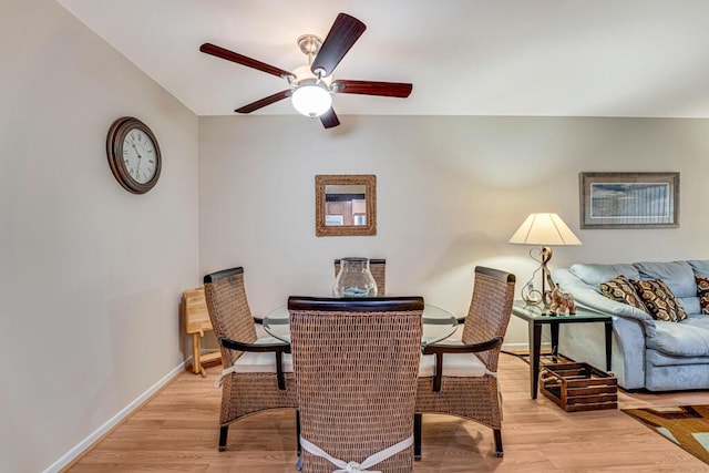 dining room with ceiling fan and light wood-type flooring