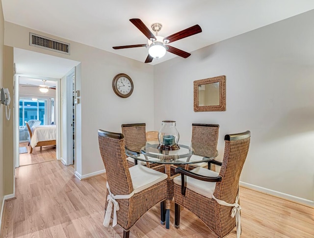 dining space featuring ceiling fan and light hardwood / wood-style floors