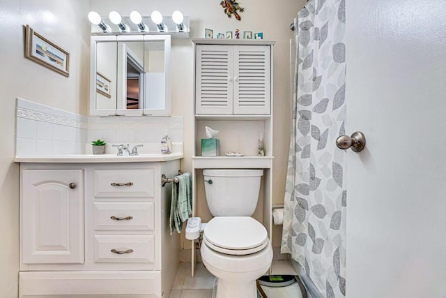 bathroom with tile patterned flooring, vanity, walk in shower, and toilet