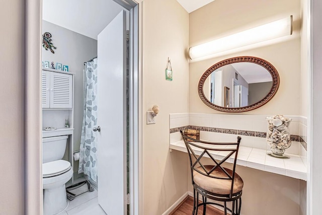 bathroom with tile patterned floors and toilet