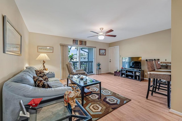 living room with hardwood / wood-style flooring and ceiling fan