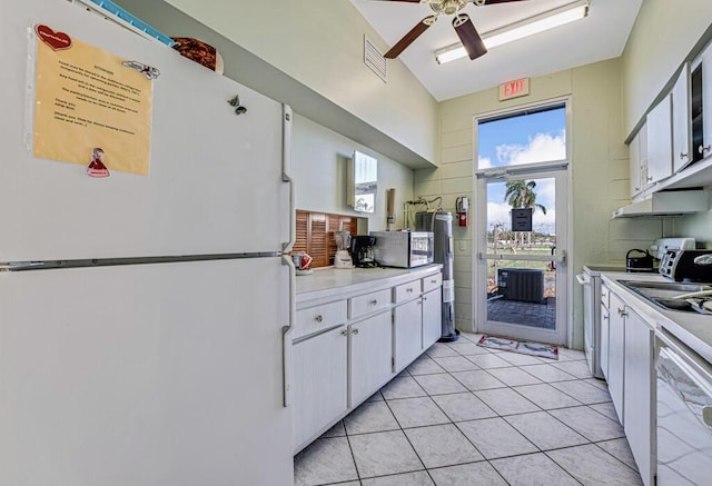 kitchen with ceiling fan, light tile patterned flooring, white cabinets, and white refrigerator