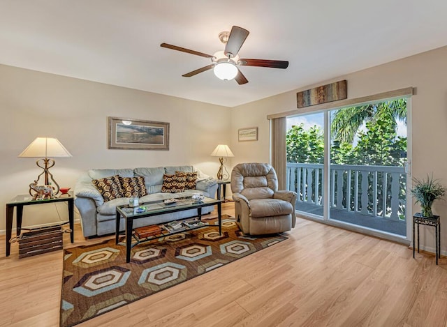 living room featuring light hardwood / wood-style floors and ceiling fan