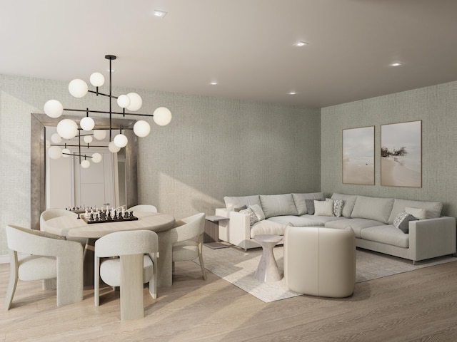 living room with an inviting chandelier and light hardwood / wood-style flooring