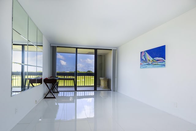 spare room with tile patterned flooring and floor to ceiling windows