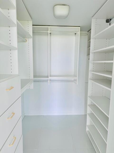 spacious closet featuring light tile patterned floors