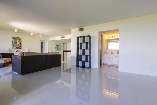 living room featuring rail lighting and light tile patterned floors