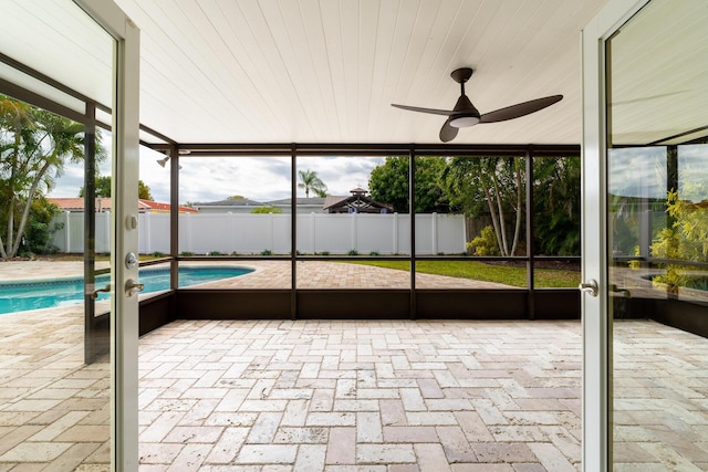 unfurnished sunroom with plenty of natural light and ceiling fan