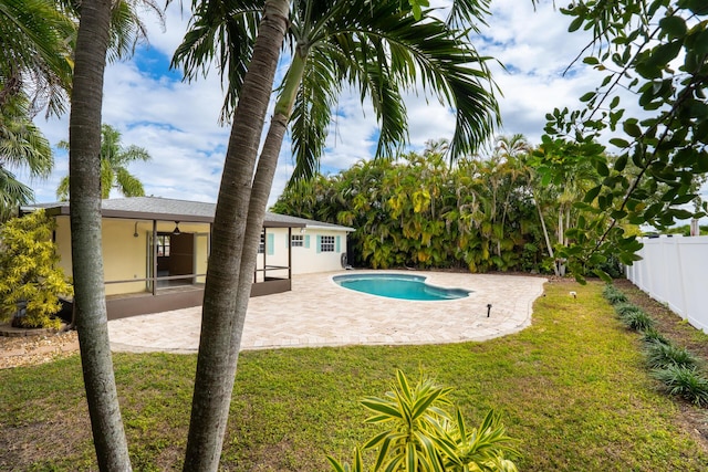 view of pool with a lawn, a patio area, fence, and a fenced in pool