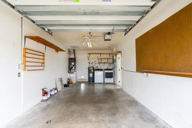 garage with washing machine and dryer, water heater, and a garage door opener
