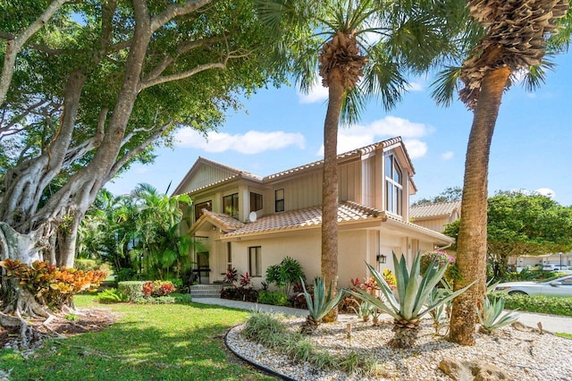 rear view of house featuring a yard