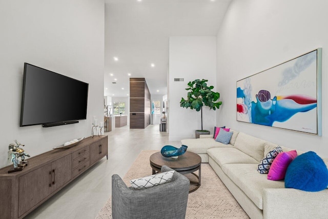 living room with a towering ceiling