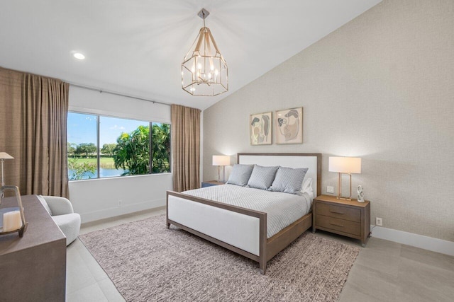 bedroom with an inviting chandelier, vaulted ceiling, and a water view