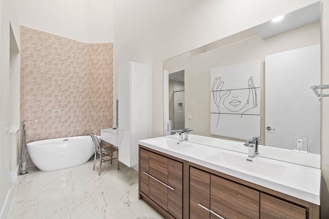 bathroom with vanity and a washtub