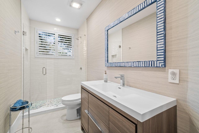 bathroom featuring vanity, tile walls, walk in shower, and toilet