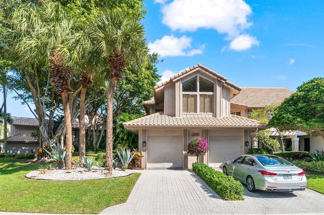 view of front of house with a garage and a front yard