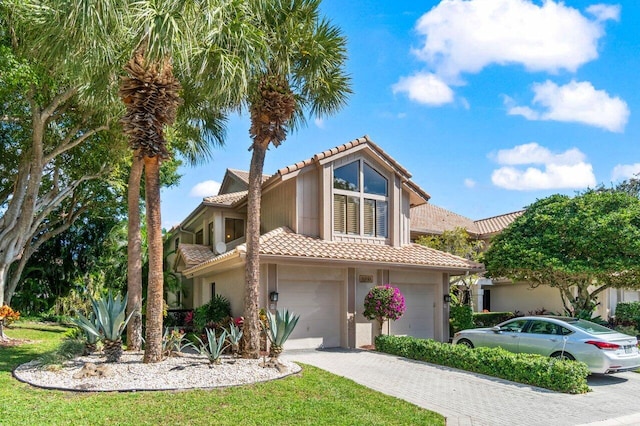 mediterranean / spanish-style house with a garage