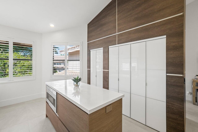 spacious closet with light tile patterned floors