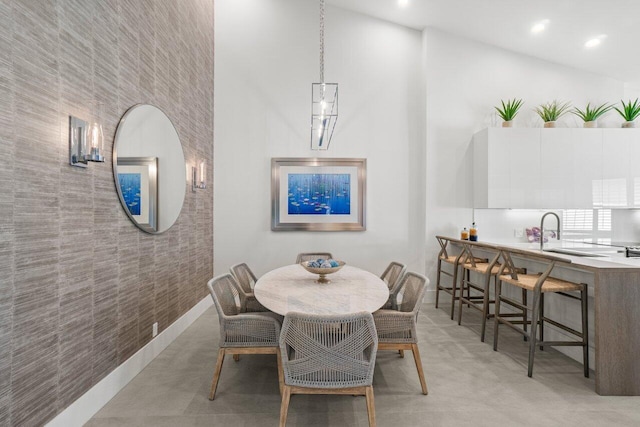 dining area with a high ceiling and sink