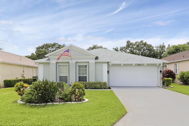 ranch-style house featuring a garage and a front lawn