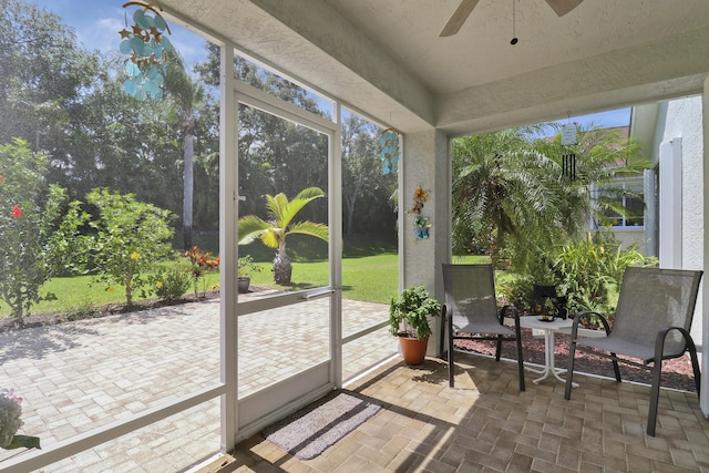 sunroom / solarium with a wealth of natural light and ceiling fan