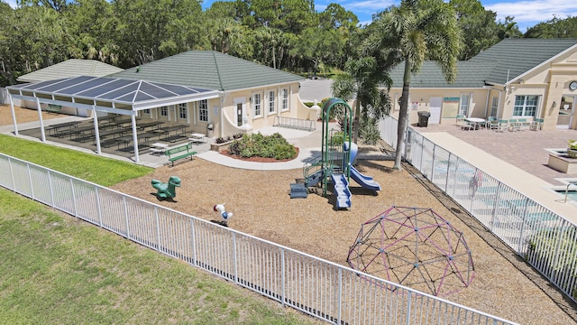 view of property's community with a playground and a patio area