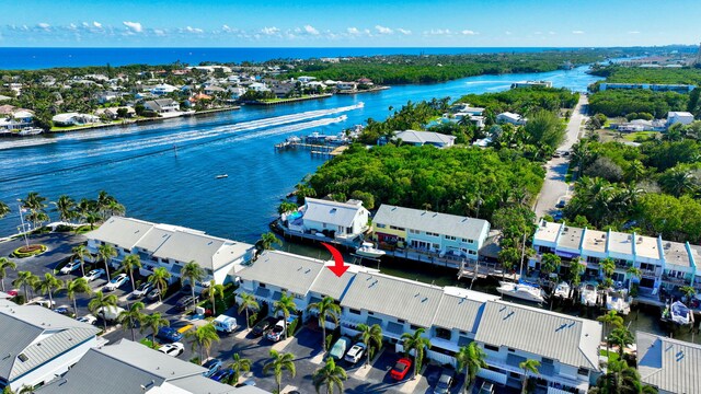 birds eye view of property with a water view and a residential view