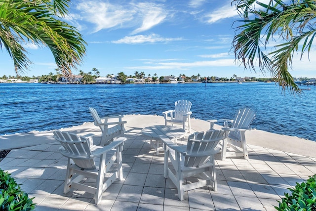 view of dock with a water view and a patio area