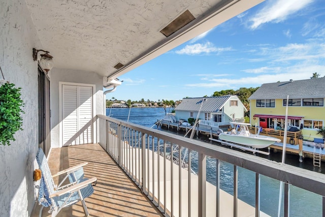 balcony featuring a water view and a residential view