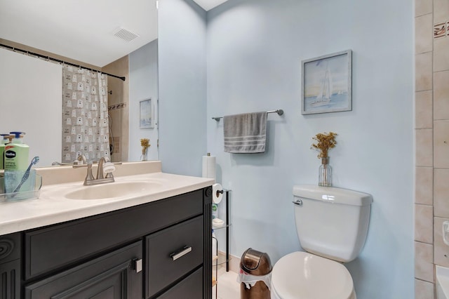 bathroom with vanity, curtained shower, and toilet