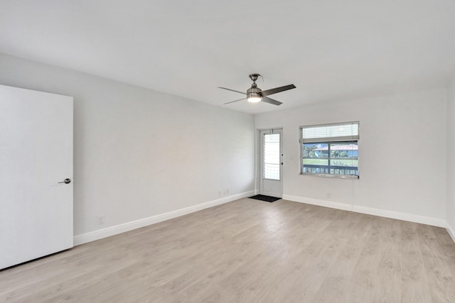 spare room featuring light hardwood / wood-style flooring and ceiling fan