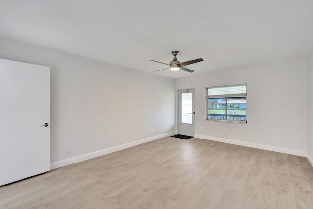 spare room featuring light wood-type flooring and ceiling fan