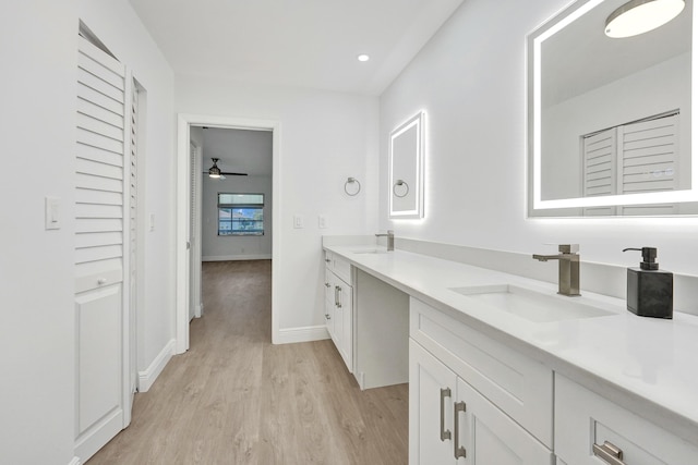 bathroom with hardwood / wood-style flooring, vanity, and ceiling fan