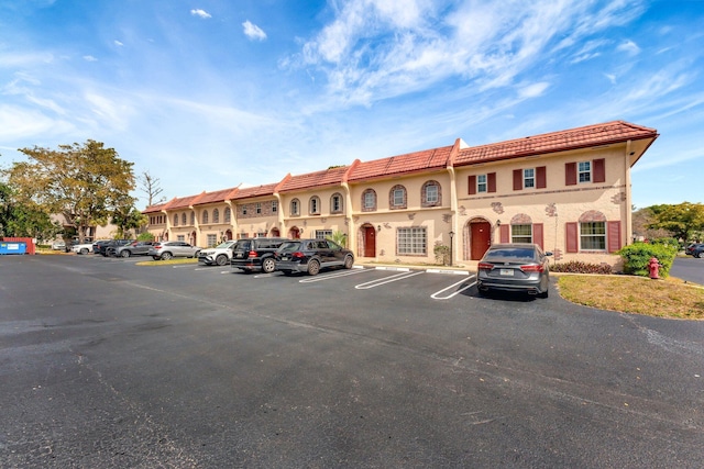 view of property with uncovered parking