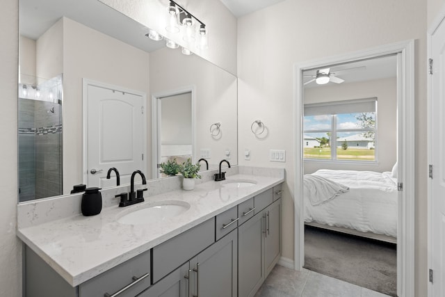 bathroom featuring vanity, a tile shower, tile patterned floors, and ceiling fan