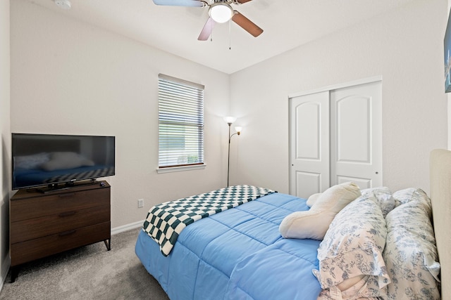 carpeted bedroom featuring ceiling fan and a closet