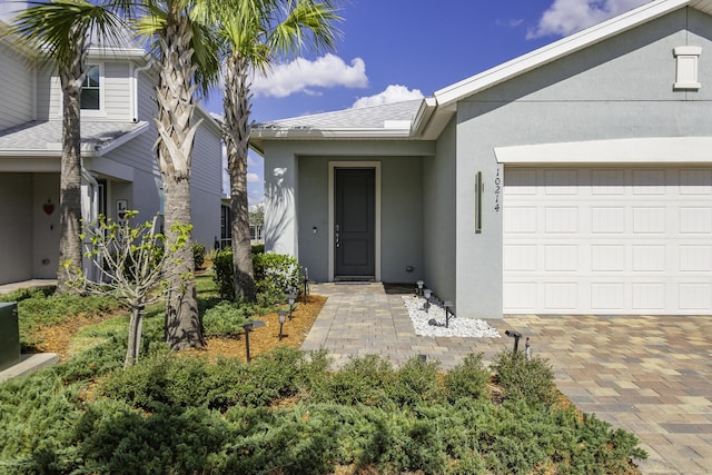 view of exterior entry with a garage