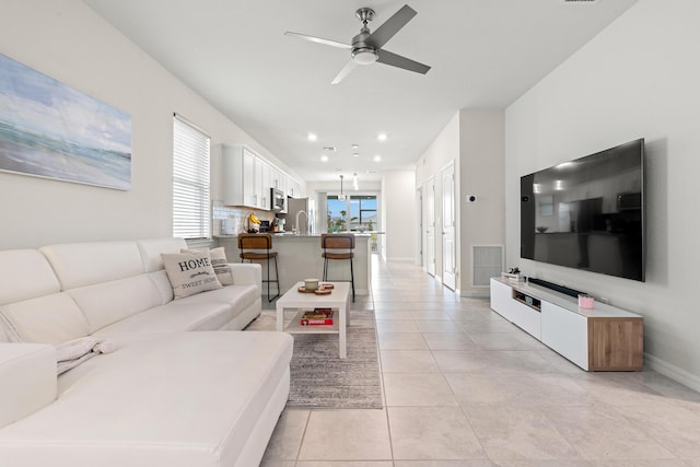 tiled living room featuring ceiling fan