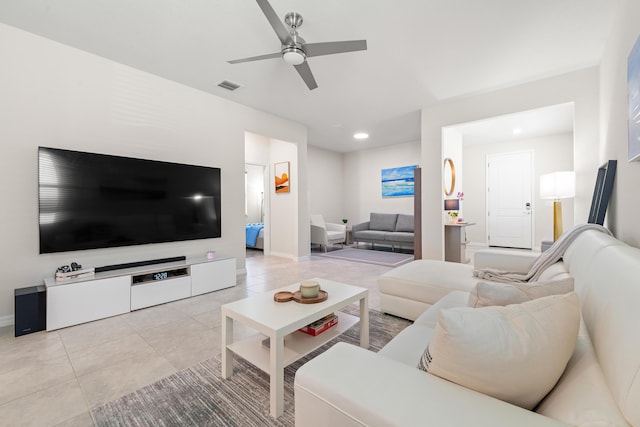 tiled living room with ceiling fan