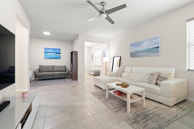 tiled living room featuring ceiling fan