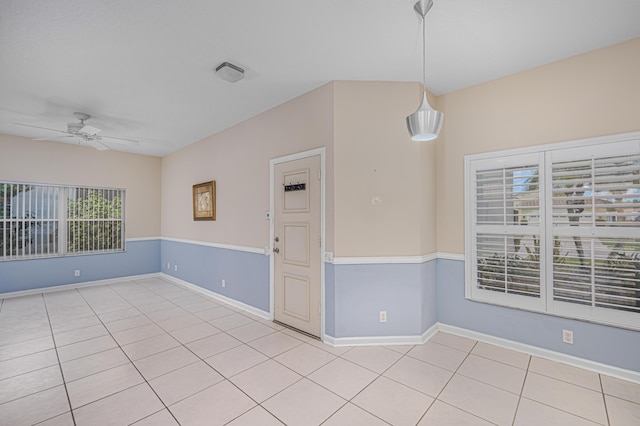 tiled empty room with ceiling fan