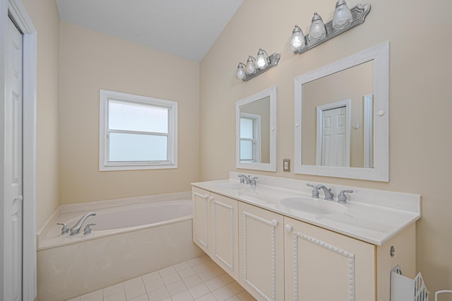 bathroom with vanity, a bathtub, tile patterned floors, and a textured ceiling